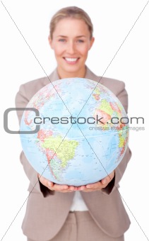 Confident businesswoman holding a terrestrial globe 