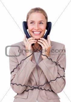 Charming businesswoman tangled up in phone wires 
