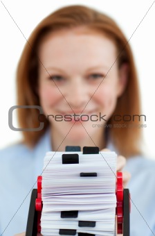Young businesswoman consulting her business card holder