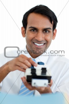 Smiling businessman searching for the index 