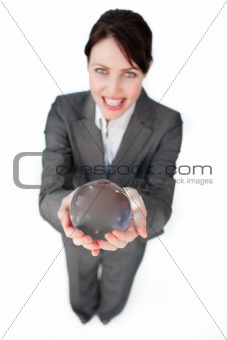 Smiling businesswoman holding a crystal ball 