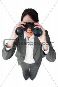 Self-assured businesswoman looking through binoculars 