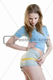Slim girl with measure tape on white