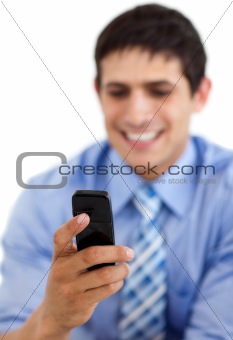 Smiling businessman sending a text 