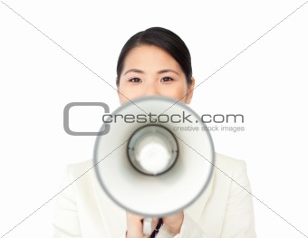 Young businesswoman shouting through a megaphone 