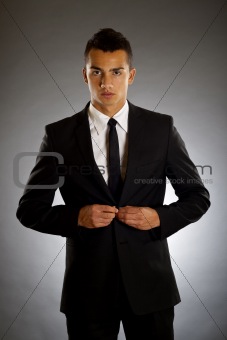 businessman buttons up
