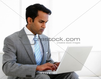 Self-assured businessman working on his computer 