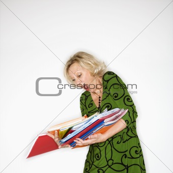 Businesswoman dropping folders