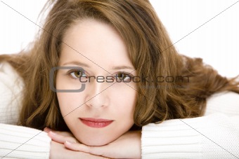Young woman having chin on hands and smiles happy