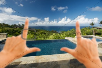 Hands Framing Pool and Hot Tub Overlooking the Ocean