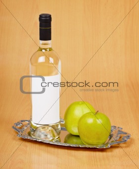 Apple wine in closed bottle on tray