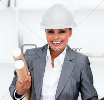 Positive female architect holding blueprints