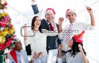 Business team punching the air to celebrate christmas 