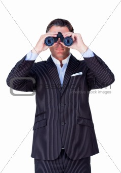 Serious businessman using binoculars 
