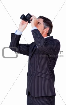 Confident businessman looking through binoculars