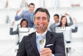 Prosperous manager and his team drinking champagne