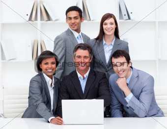 Successful business team looking at a laptop
