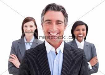 Self-assured businessman posing in front of his team