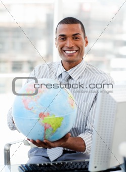 Ethnic businessman holding a terrestrial globe