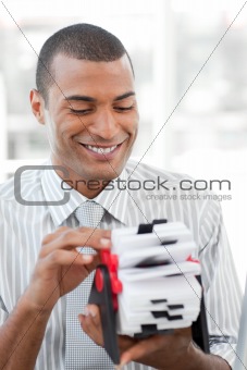 Attractive businessman consulting a business card holder