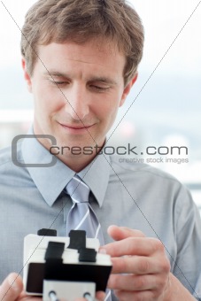 Businessman consulting a business card holder 