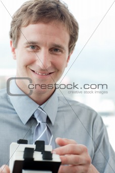 Smiling businessman holding a business card holder