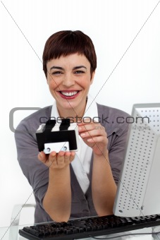 Smiling businesswoman holding a business card holder 