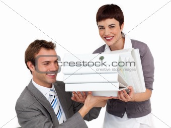 Smiling Businesswoman bringing a stack of folders to her manager