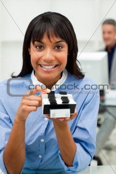 Self-assured businesswoman holding a business card holder