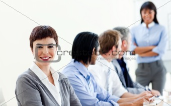 Attractive businesswoman in a meeting with her colleagues 