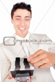 Confident ethnic businessman consulting a business card holder 