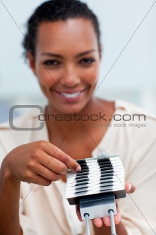 Confident businesswoman consulting a business card holder