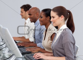 Serious International business team working at computers 