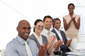 Multi-ethnic business people applauding after a presentation