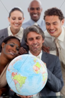 A business group showing ethnic diversity holding a terretrial g
