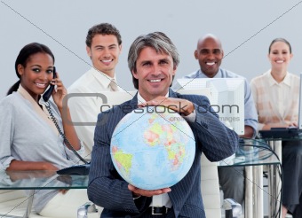 Fortunate business team at work showing a terrestrial globe 