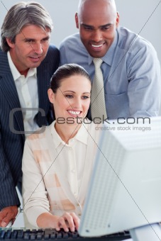 Assertive business people working at a computer