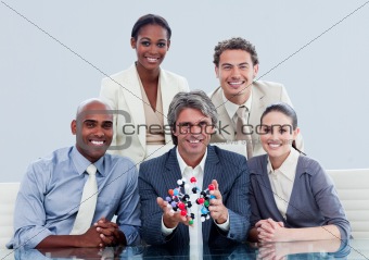 Ambitious business team showing a molecule 