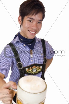 Happy smiling Asian man in Lederhose holds Oktoberfest beer stein
