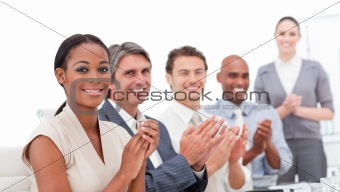 A diverse business group applauding a good presentation