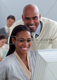 Portrait of two enthusiastic businesspeople working at a compute