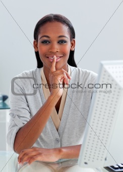 Confident businesswoman asking for silence at her desk