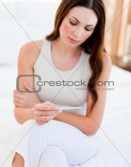 Sad woman finding out results of a pregancy test