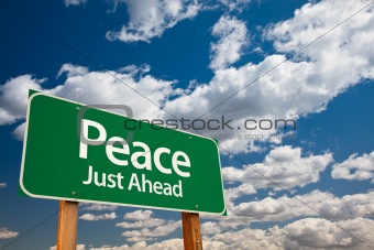 Peace, Just Ahead Green Road Sign with Copy Room Over The Dramatic Clouds and Sky.