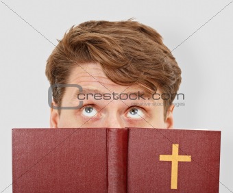 Young man thinks after bible reading