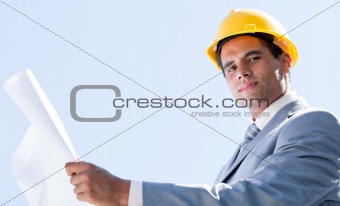 Smiling male architect holding a blueprint