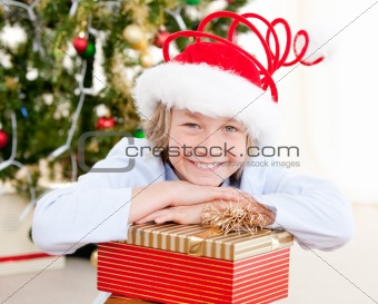 Smiling child opening his present at christmas time