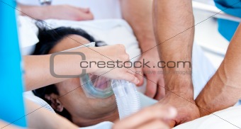 Medical team giving oxygen mask to the patient