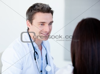 Smiling doctor talking with his patient 