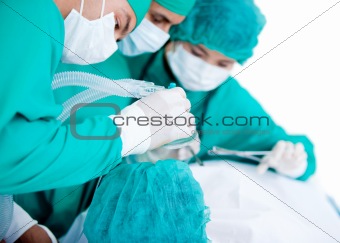 Professionnal medical team using surgery equipment on a patient in the hospital
